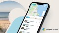 Abbildung eines Handyscreens auf dem die neue Ostsee Guide App abgebildet ist (Startscreen mit Kartenausschnitt der Region Scharbeutz)
