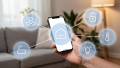 A cell phone screen is the focal point of the image, held in a hand. Six icons related to digitalization and cybersecurity pop out of the screen.