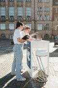 Two women are standing at a high table in the evening sun on Kiel