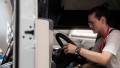 A person inside of the cabin of a truck, testing the functions.