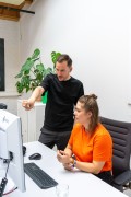 Office situation: Two persons looking at a computer.